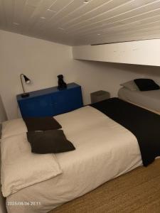 a bedroom with a bed and a blue dresser at Le Baigura in Saint-Pierre-dʼIrube