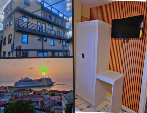 a white refrigerator next to a building and a cruise ship at Oceanview Suites in Saint Georgeʼs