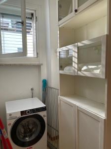 a laundry room with a washing machine and a window at Historic Center Penthouse 6 minutes from the Station in Ravenna