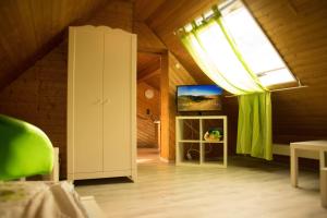 a attic room with a window and a television at Unterkunft4You-Ferienhaus-Zum-Burgfried in Usingen