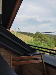 a window with a view of a field from a train at Zlatarski kutak L&D in Nova Varoš
