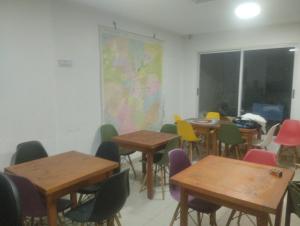 a classroom with tables and chairs with a map on the wall at hostel plaza brasil in Santiago +1 photo