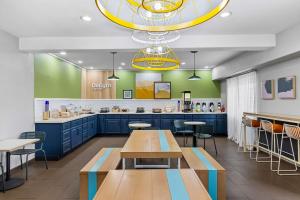 a fast food restaurant with blue cabinets and tables at Spark by Hilton Phoenix-Glendale-Peoria in Glendale