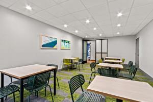 a classroom with tables and chairs in a building at Spark by Hilton Phoenix East Mesa in Mesa +57 photos