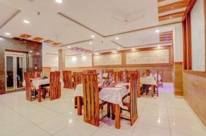 a dining room with tables and chairs in a restaurant at Pushap villa katra in Katra