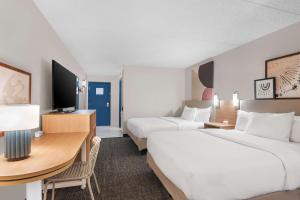 a hotel room with two beds and a desk at Spark By Hilton St. Augustine Historic District in Saint Augustine +16 photos