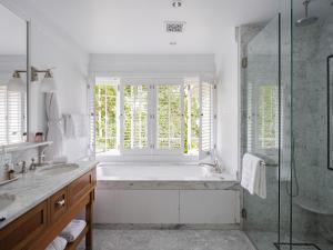 a white bathroom with a tub and a window at El Encanto Santa Barbara in Santa Barbara