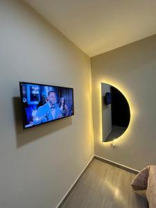 a living room with a flat screen tv on a wall at Milenio in Manta