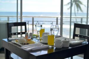 a table with wine glasses and a plate of food at Bohol South Beach Hotel in Panglao
