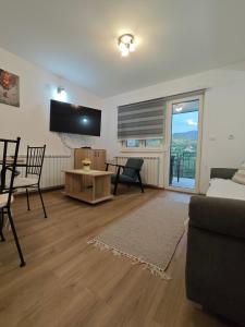 una sala de estar con un sofá y una mesa en Jovičića Kuća, en Mokra Gora