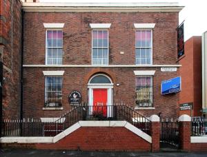 a red brick building with a red door at Pembroke Place Private Room 12A in Liverpool