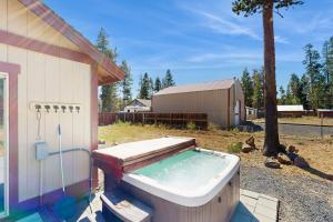 a bath tub sitting outside of a house at Wood Wonderland in Sunriver