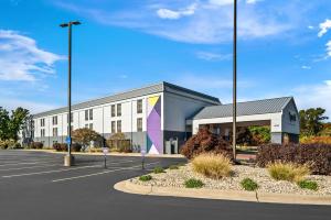 an office building with a parking lot at Spark By Hilton Stevensville in Stevensville