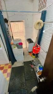 a room with a door and a room with a toilet at Recámara en Casa Alan in Puerto Vallarta +10 photos