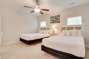 a bedroom with two beds and a ceiling fan at 3 Mi to Sand and Surf Ocean Isle Beach Retreat! in Ocean Isle Beach