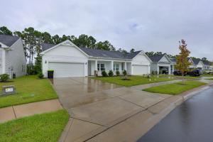 a row of houses with a driveway at 3 Mi to Sand and Surf Ocean Isle Beach Retreat! in Ocean Isle Beach
