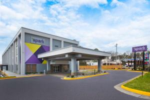 a large building with a sign in front of it at Spark By Hilton Jackson Ridgeland in Jackson