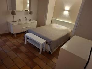 a small bedroom with a bed and a table at Bastide la Bohême in La Ciotat +24 photos