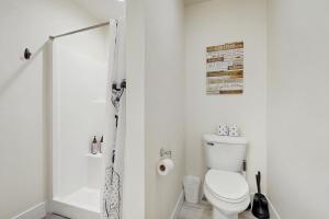 a white bathroom with a toilet and a shower at Bridger View Retreat in Belgrade +14 photos