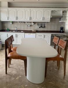 a kitchen with a white table and two chairs at Tenerife Stay Ocean Front I in San Marcos