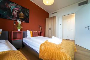 a bedroom with two beds and a painting on the wall at Wonderful Apartment with 2 bedrooms and pool and parking in Vienna +80 photos