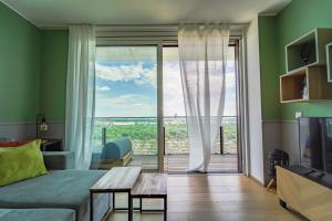 a living room with a couch and a sliding glass door at Wonderful Apartment with 2 bedrooms and pool and parking in Vienna