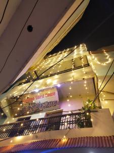 a sign on the side of a building with lights at Maa Vaishno Guest House in Varanasi