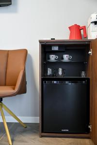 a chair and a television in a room at Luxury rooms Iva in Zadar