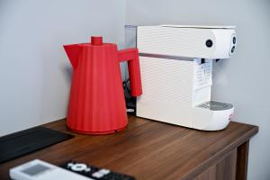 a red blender sitting on a desk next to a toaster at Luxury Rooms by Iva in Zadar