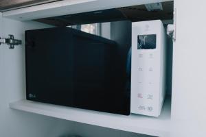 a wii remote control on a shelf at Portside studio, free parking, self check-in in Klaipėda
