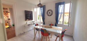 a dining room with a table and chairs at Le maupassant in Le Havre