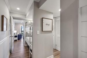 a room with a hallway with bunk beds at Unspoiled Beachfront Villa Sunrises from Balcony in Hilton Head Island