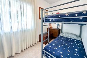 a bedroom with a bunk bed with an american flag bedspread at Apartment La Perla, Los Cristianos in Los Cristianos