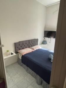 a bedroom with a bed and a flat screen tv at Praia de Botafogo próximo a Copacabana in Rio de Janeiro