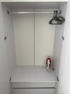 a closet with white walls and a white shelf at Praia de Botafogo próximo a Copacabana in Rio de Janeiro