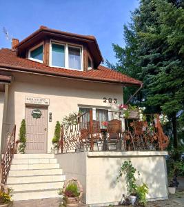 a house with a balcony with chairs on it at KRK stop in Cholerzyn
