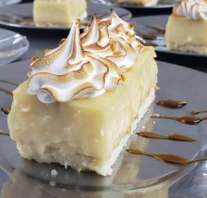 a piece of cheesecake with whipped cream on a plate at Hotel Intersur La Cumbre in La Cumbre