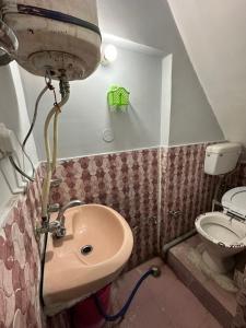 a bathroom with a sink and a toilet at Pearl Homestay Mussoorie in Mussoorie