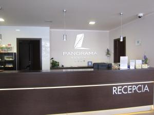 a sign for a parrotana resort and a reception desk at Apartman 106 Panorama Resort Štrbské Pleso in Vysoke Tatry - Strbske Pleso