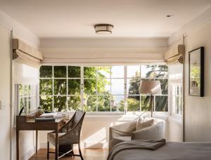 a bedroom with a desk and a large window at El Encanto Santa Barbara in Santa Barbara