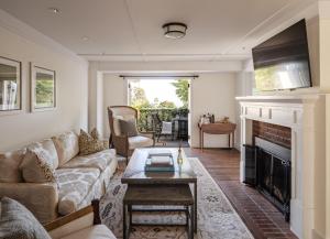 a living room with a couch and a fireplace at El Encanto Santa Barbara in Santa Barbara