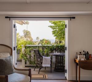 an open door to a patio with chairs and a table at El Encanto Santa Barbara in Santa Barbara