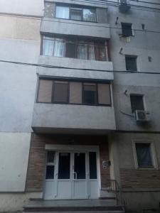 a tall building with a white door and windows at Sky KATERINNA in Brăila