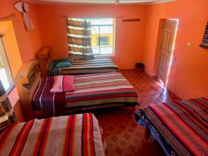 Кровать или кровати в номере Mosoc pacha lodge amantani