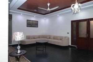 a living room with a couch and a table at Executive Residency Lahore in Lahore +80 photos