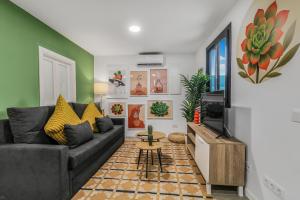 a living room with a couch and a tv at Living Central Stay Bejeque in Vecindario