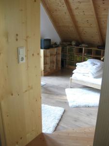 an attic room with a bed and a room with rugs at Villa Domus in Krems an der Donau