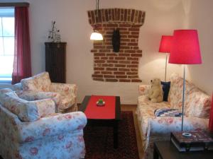 a living room with two chairs and a teddy bear at Villa Domus in Krems an der Donau