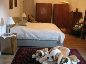 a bedroom with a bed with stuffed animals on the floor at Villa Domus in Krems an der Donau