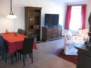 a living room with a dining table and a tv at Villa Domus in Krems an der Donau +20 photos